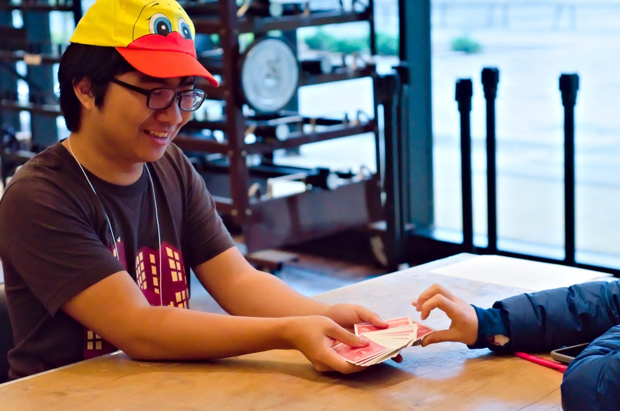 me, fanning out a deck of cards for someone who’s reaching to grab it