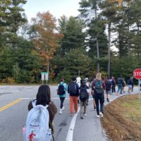 us walking by a road